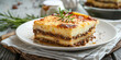 Moussaka on a white wooden table, Layers of potato and lamb, mediterranean flavors, cafe or homely background