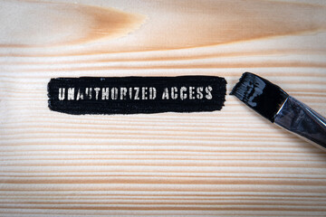 Wall Mural - Unauthorized Access. Black paint and paint brush on wood texture background