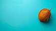 © VISUAL BACKGROUND - A coconut on a blue background.
