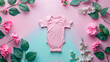 © VISUAL BACKGROUND - A pink baby bodysuit on a blue background with flowers.