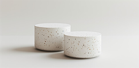 two white terrazzo cylinder podiums in different sizes, on white background, minimalism