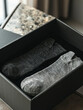 A pair of socks in a black box.