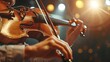 © Nawarit - A violinist playing a classical music piece on a vintage violin under a spotlight on a dark stage