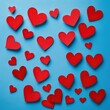 Scattered Affection: A Collection of Red Paper Hearts on a Calming Blue Background.