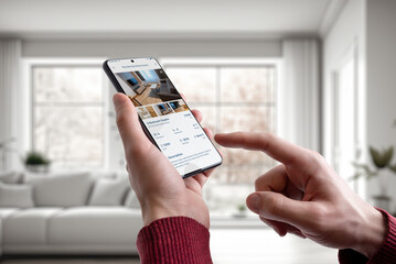 Guy at home using a smartphone with a residential real estate app. Modern technology merges seamlessly with the comfort of home for convenient property exploration