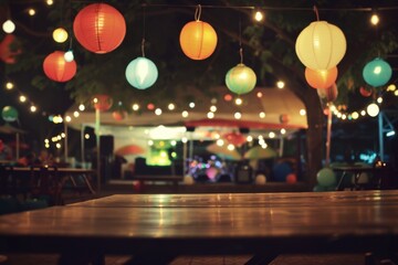 A blurry, out of focus photo of the dance floor at night under a canopy with hanging lights and large round lantern light garlands In front is an empty table with chairs Generative AI