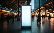 © FATNA - Mock up. Vertical advertising billboard, lightbox with empty digital screen on railway station. Blank white poster advertising, public information board stands at station in front of people and train