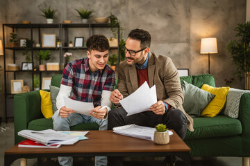 Adult professor mentor and young student hold papers and renew lesson