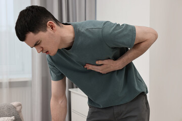 Canvas Print - Young man suffering from heart hurt at home