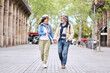 © CarlosBarquero - Happy adult Caucasian tourist couple looking at each other walking holding hand for street in city. Mature people in love enjoying romantic getaway. Positive relationships and spring retiree holidays
