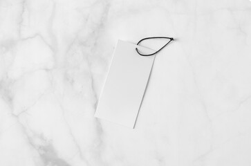 Canvas Print - Rectangular clothing tag, gift tag mockup on a white marble background.