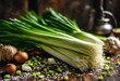 a bunch of green onions are sitting on a table near some spices