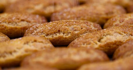 Wall Mural - high-calorie custard cookies on paper, delicious sweet cookies with sugar on the table