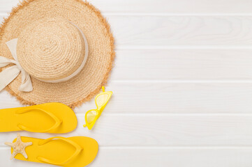 Flat lay with colorful beach accessories on wooden background. Vacation concept