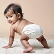 © TexasOptics - Image of a cute Indian baby crawling only wearing a diaper.