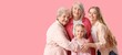 © Pixel-Shot - Little girl with her family hugging on pink background with space for text