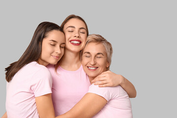 Poster - Portrait of hugging women on grey background. Women history month