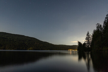 Wall Mural - night scene on mountain lake with calm water and cloudy sky