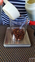 a bowl of coffee beans on the digital measure