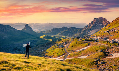hiker takes photo from sedlo pass. picturesque spring scene of durmitor national prk. amazing mornin