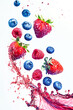 Blueberry, strawberry and raspberry flying in splash on white background.