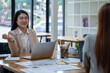 © Surachai - Two Asian businesswomen working Creative discussion in office using laptop and tablet, business concept