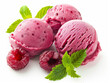 Three pink ice cream scoops with raspberries and mint leaves on top