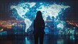 A woman stands in front of a large screen displaying a map of the world