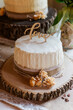 Rustic wedding cake with 'Love' topper on a wooden slice
