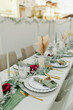 Boho wedding table place setting with green accents and pampas grass