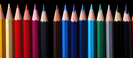 Poster - A set of colored pencils isolated on a black background perfect for back to school projects with ample copy space image