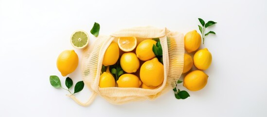 Poster - Flat lay copy space image showcasing the zero waste concept with a variety of eco friendly bags including string mesh and grocery bags A lemon sits on a white background adding a fresh touch Top view