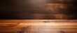 © HN Works - A wooden cutting board on a brown table is captured in a panoramic shot with plenty of copy space for potential images