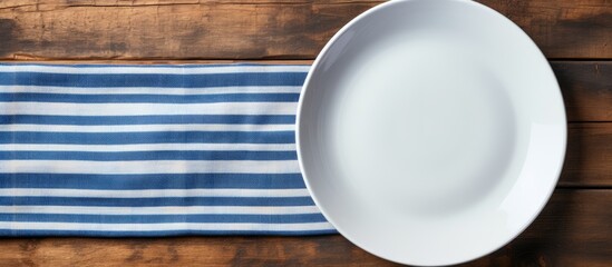 Aufkleber - Copy space image of a white plate resting on a striped napkin on the backdrop of an aged wooden table