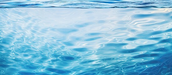 Leinwandbilder - Top view of a clear water surface with rippling patterns set against a light blue background creating a visually appealing copy space image