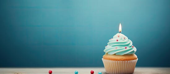 Aufkleber - A homemade cupcake with a lit candle is placed on a simple background creating a cheerful birthday greeting card The copy space image also includes a gift box for the birthday holiday celebration