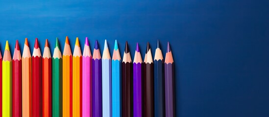 Poster - A vibrant collection of colored pencils and school supplies displayed in a close up copy space image
