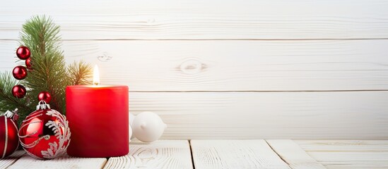 Leinwandbilder - A festive copy space image showcasing a candle and Christmas toys adorning a beautiful Christmas tree set against a backdrop of a white wooden background