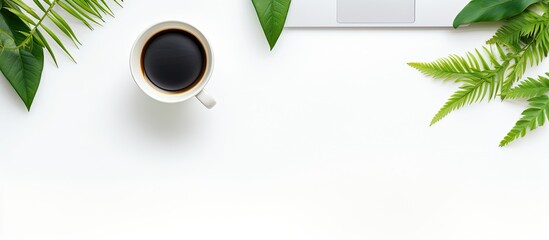 Leinwandbilder - A top down view of a desk in the office is presented as a flat lay The desk features a keyboard office supplies a green leaf and a coffee cup against a white background leaving ample copy space in th