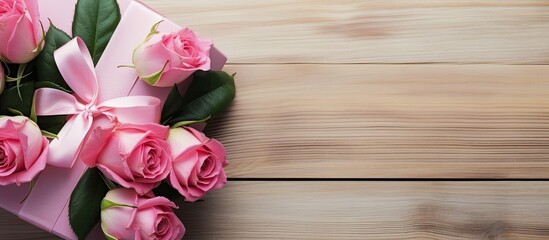 Aufkleber - A top down view of a stunning bouquet of pink roses and a gift wrapped in pink packaging placed on a white wooden surface with ample space for additional images or text