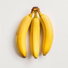 Wall Mural - Three ripe bananas resting gracefully on a white canvas