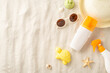 Sun safety essentials for kids at the beach. Overhead shot of sunscreen bottles, toys, straw hat, and shades on sand. Background with shells, starfish. Copy space for promotion