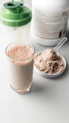 Canvas Print - Protein drink cocktail in a glass and whey protein powder in a measuring scoop