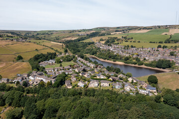 Wall Mural - Aerial photo of the historic Yorkshire town of Huddersfield in the UK, showing the residential housing estates by a lake and train viaduct on a sunny day in the summer time