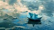 Blue paper boat floating on water with cloud reflections