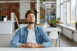 © forenna - backdrop of a modern office setting, a male IT developer engaged in meditation at his white minimalistic desk, demonstrating the importance of incorporating stress-relief technique