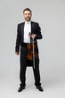 Elegant man skilled musician holding violin