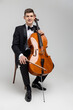 Passionate cello player sitting on chair performing concert