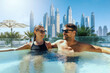 happy young couple relaxing in outdoor hot tub at Dubai hotel. luxury vacation, getaway travel