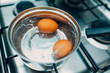 Saucepan stainless steel with boiling eggs breakfast in a water on a gas stove.
